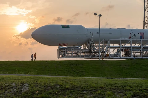 A Falcon 9 rocket launching from Cape Canaveral with the SpaceX Crew Dragon capsule attached.