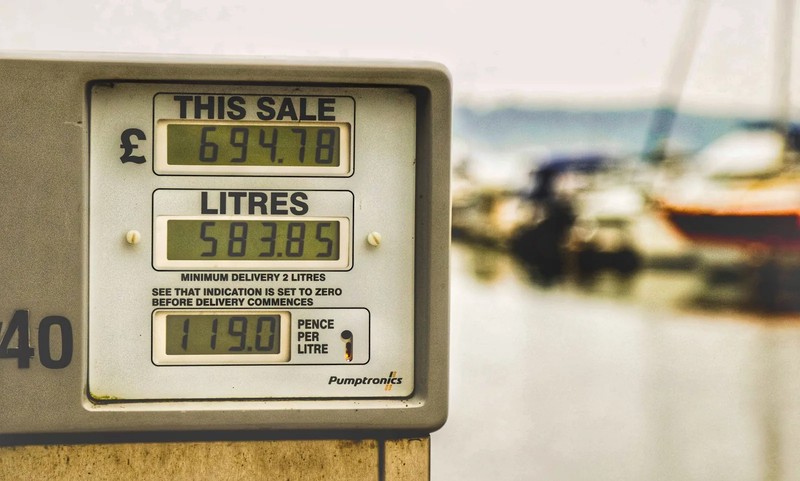 A fuel pump at a petrol station with the price displayed at £2.00 per litre