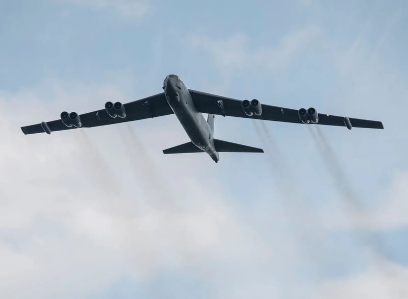 A long-range U.S. Air Force bomber preparing for departure from an active military airfield runway.